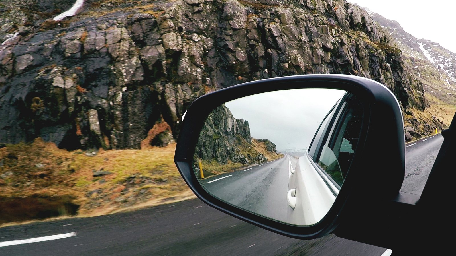 Retrovisor externo de carro em estrada